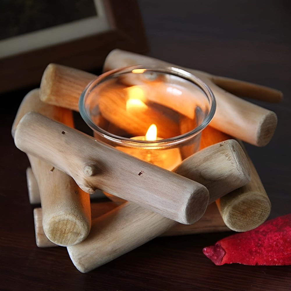 Driftwood tealight holder with a lit candle inside, made of reclaimed wood pieces.