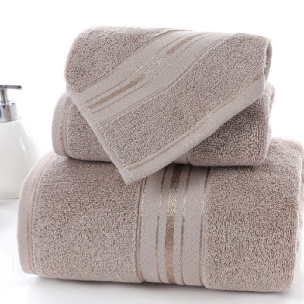 Stack of three beige Egyptian cotton towels with subtle gold stripes.