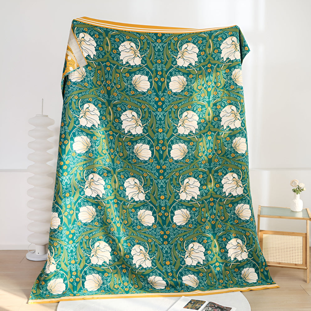Green botanical bloom cotton blanket with white flowers and yellow accents.