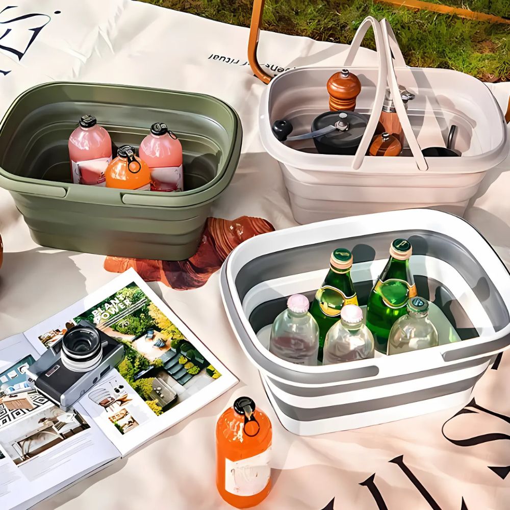 Collapsible storage baskets filled with drinks and picnic items on a blanket.