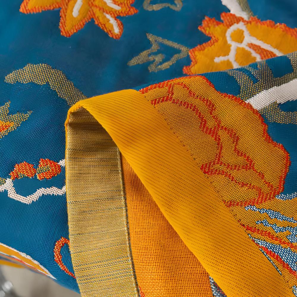 Blue cotton bath towel with yellow trim and a floral pattern.