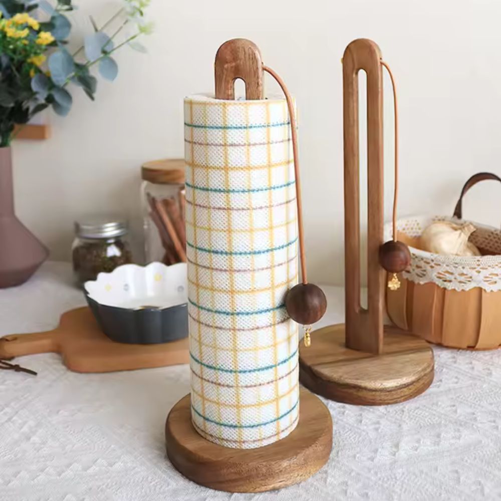 Acacia wood paper roll stand with a plaid paper towel roll and wooden balls.