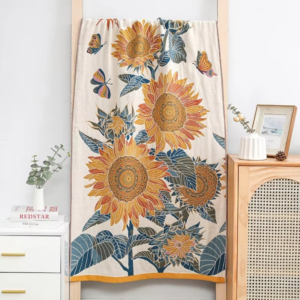 A cotton bath towel with a jacquard woven sunflower and butterfly design.