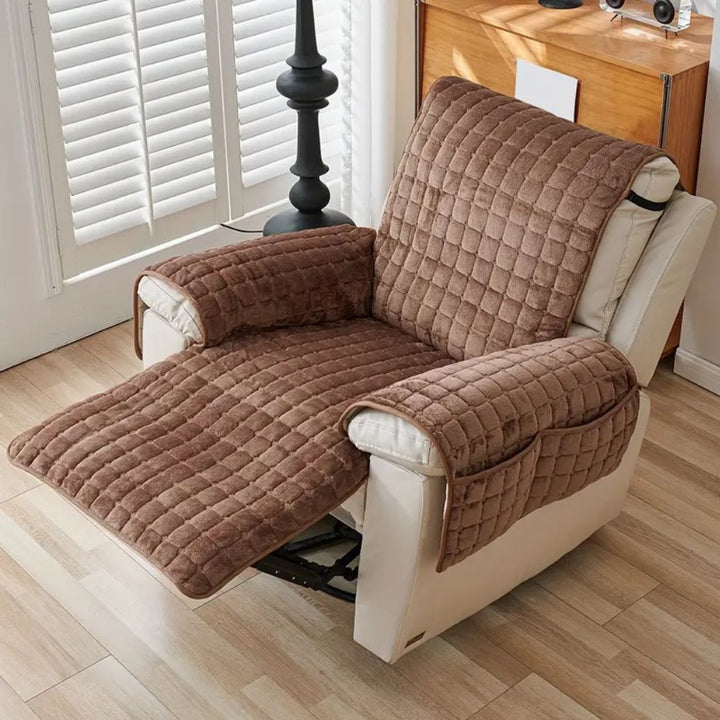 Brown quilted microfiber recliner chair cover with a side pocket, protecting a cream recliner.