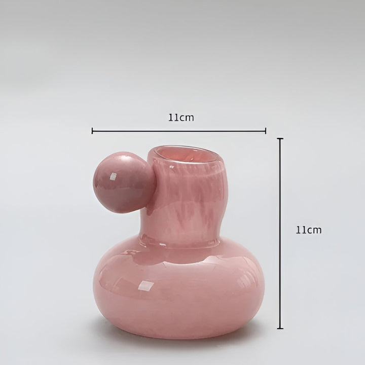 Pink glass vase with a round ball accent, 11cm wide and 11cm tall.
