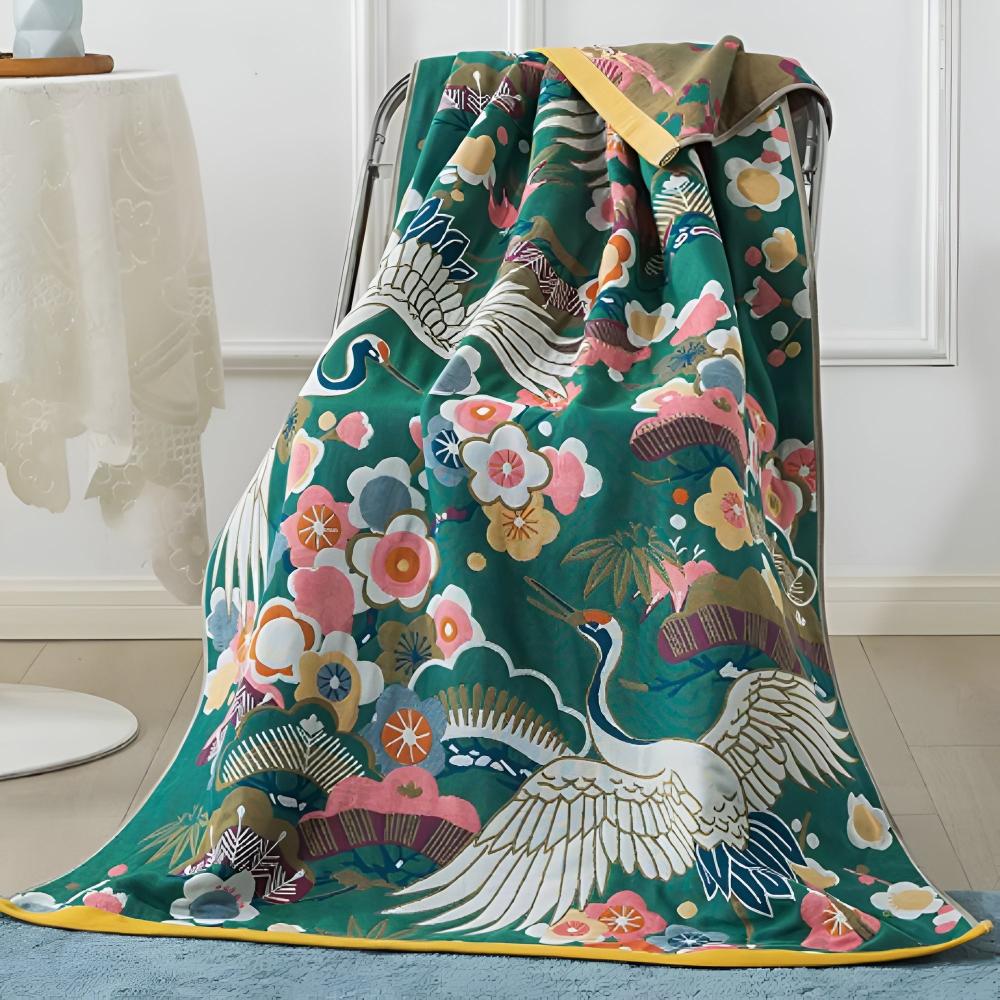 Green cotton bath towel with a crane and floral print, featuring yellow trim.