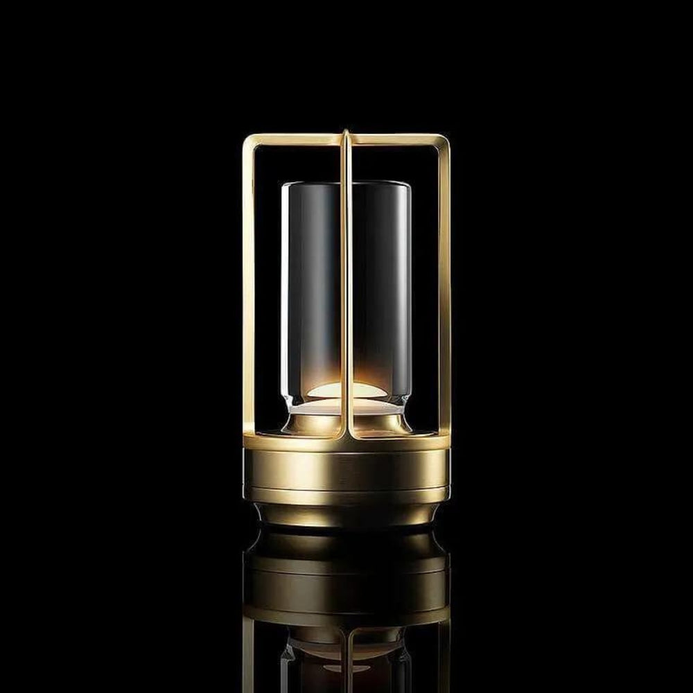 Brass lantern with a cylindrical glass shade, emitting a warm glow.