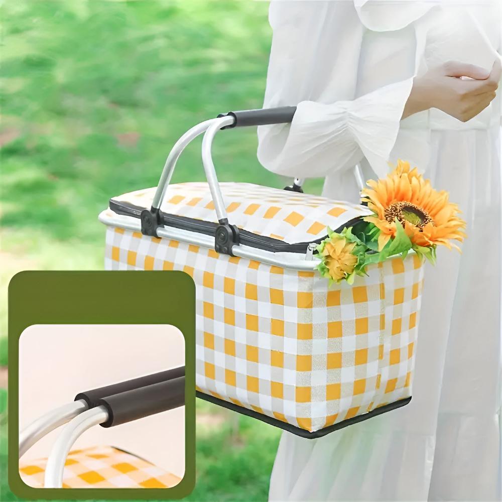 Yellow and white checkered picnic basket with a silver frame and black handles, holding sunflowers.