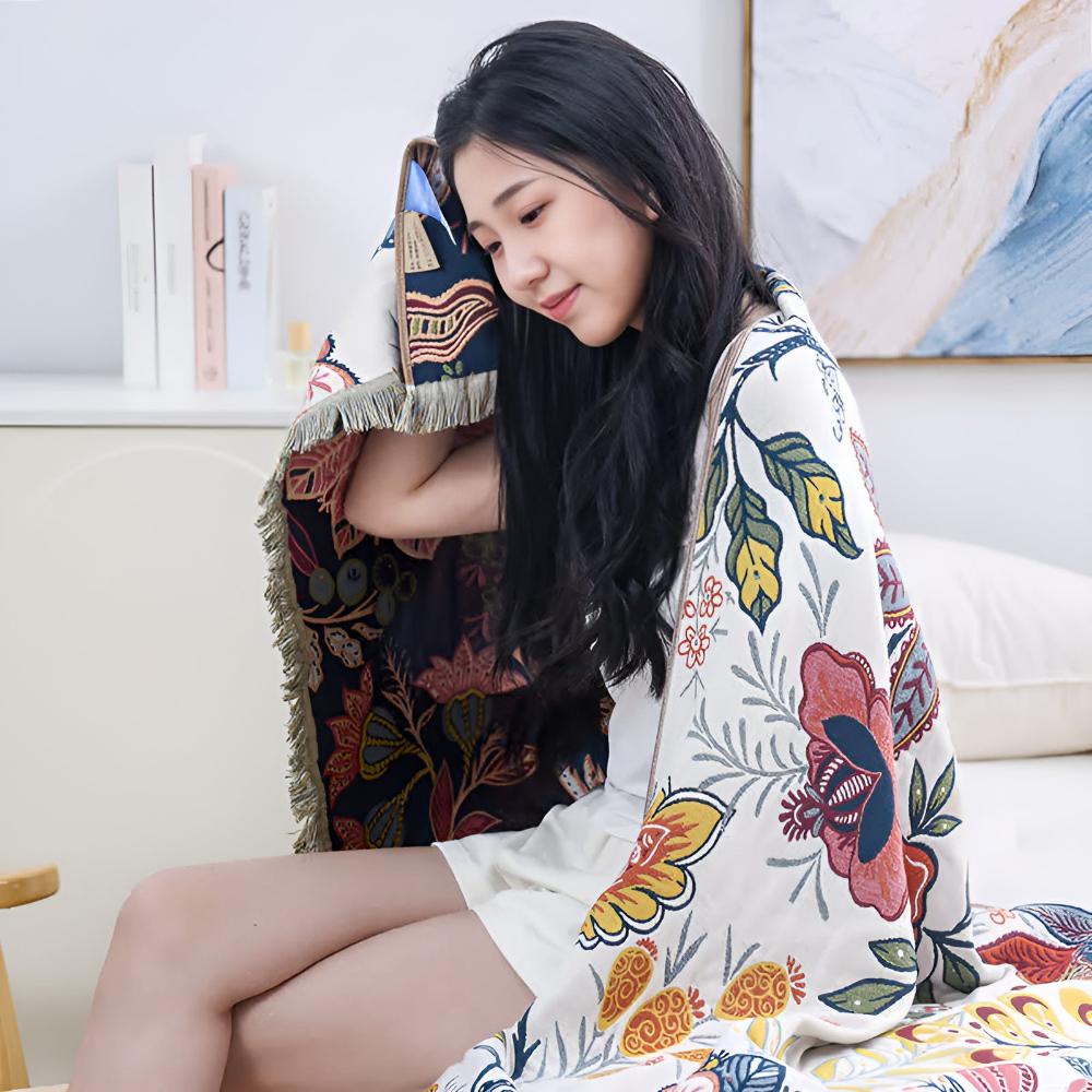 Woman wrapped in a reversible cotton bath towel with a vibrant floral print.