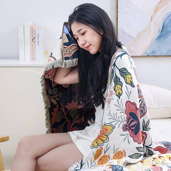 Woman wrapped in a reversible cotton bath towel with a vibrant floral print.