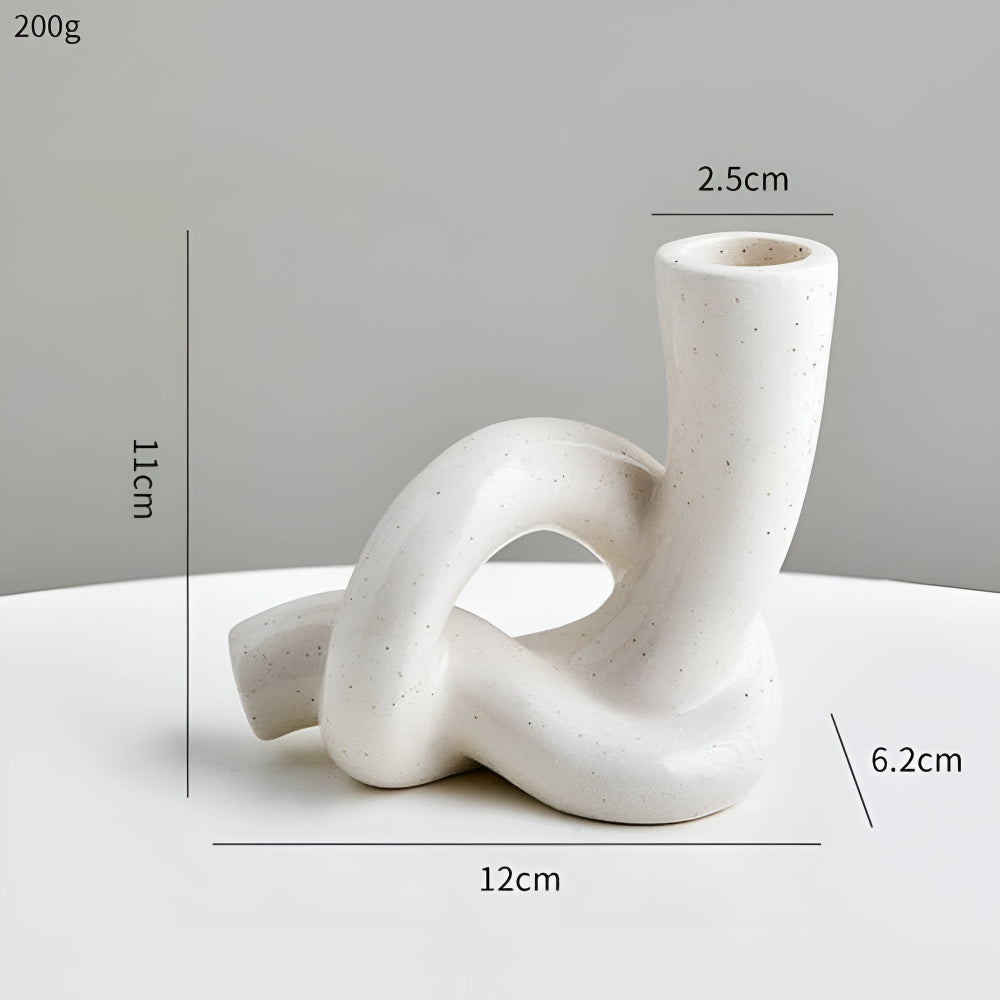 White ceramic knot candle holder, 11cm tall, 12cm wide, 2.5cm opening, 6.2cm base.