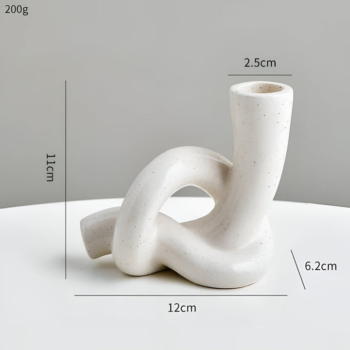 White ceramic knot candle holder, 11cm tall, 12cm wide, 2.5cm opening, 6.2cm base.