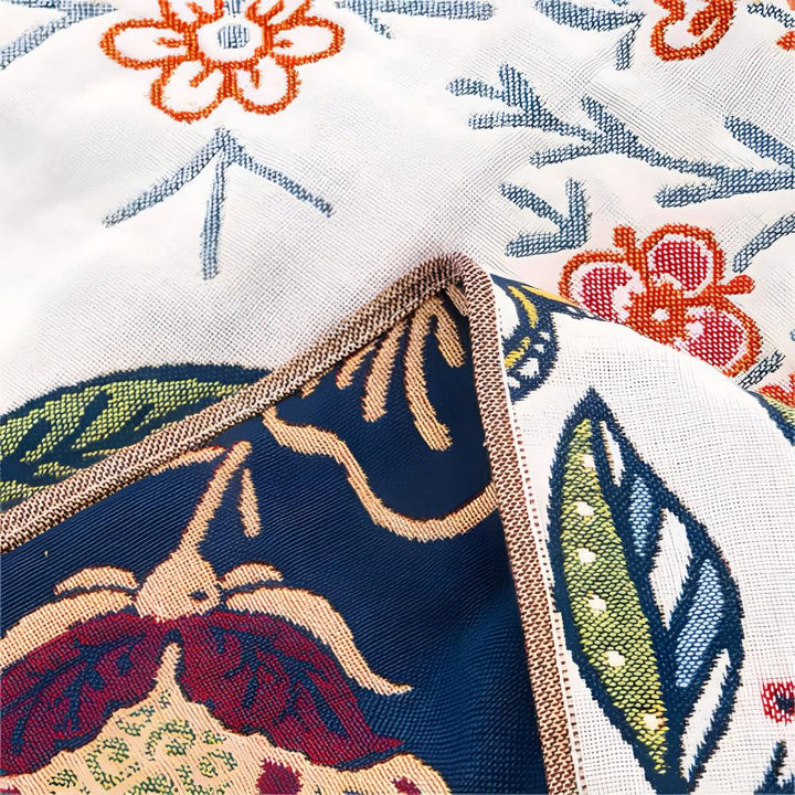 Reversible cotton bath towel with a garden floral print in blue, orange, and green.