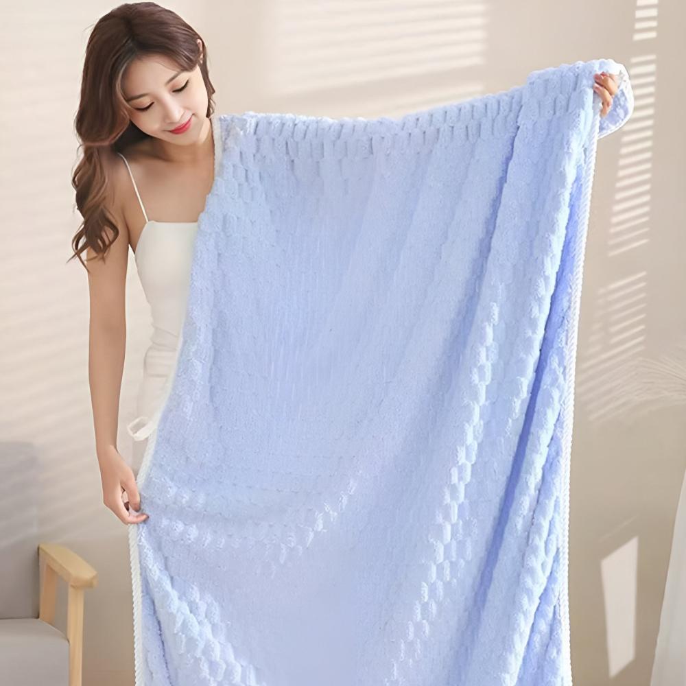 Woman holding a light blue soft fleece towel.