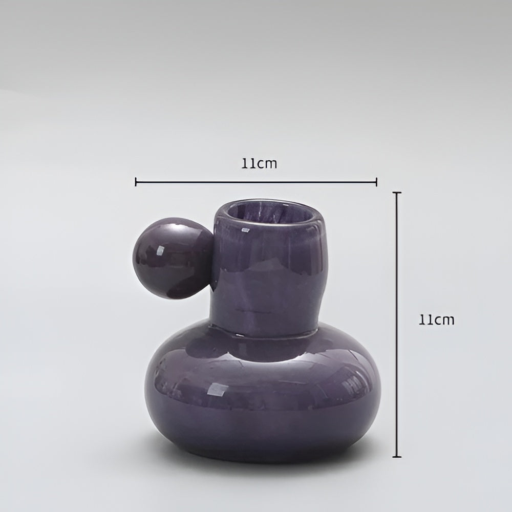 Purple glass candle holder with a round ball accent, measuring 11cm in height and width.
