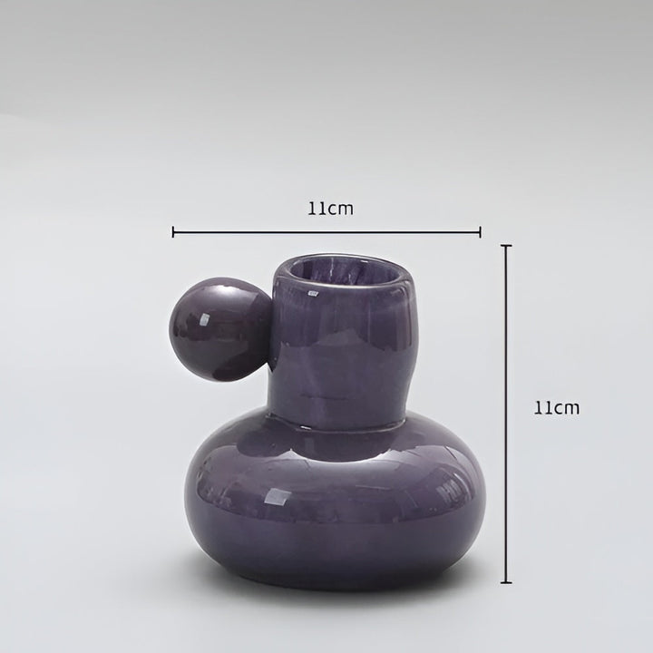 Purple glass candle holder with a round ball accent, measuring 11cm in height and width.