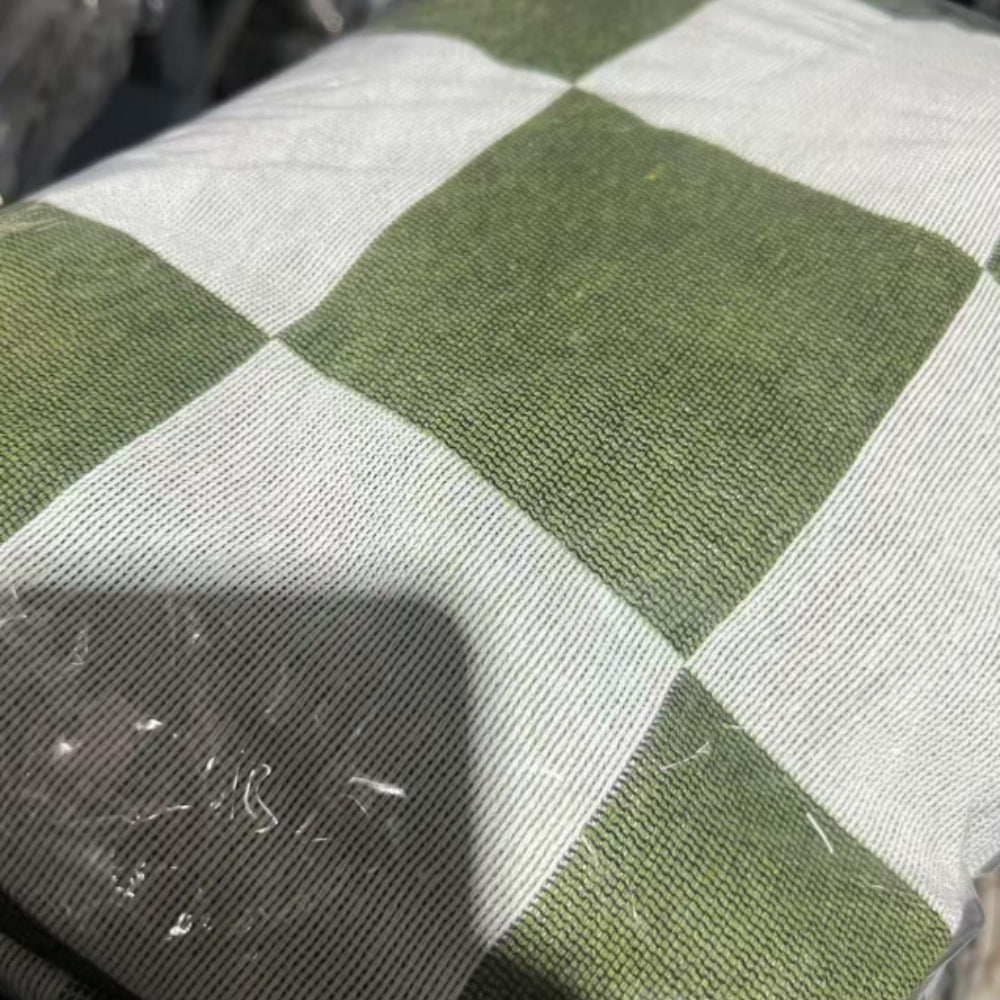Green and white checkered picnic blanket with fringe, made of microfiber.