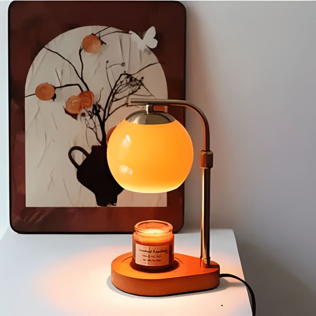 Sculpted glass candle warmer lamp with a retro amber globe and a lit candle on a wooden base.