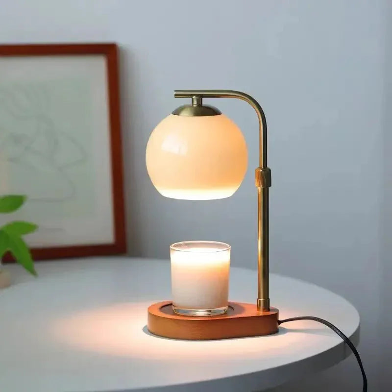Sculpted Glass Candle Warmer Lamp with a warm glow, featuring a glass shade and a wooden base holding a candle.