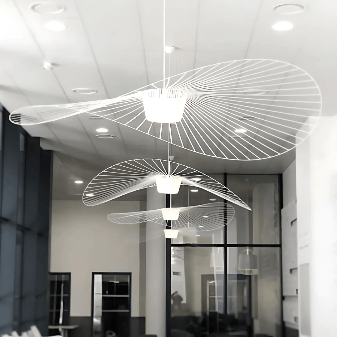 Contemporary pendant light with a white, spiraling design, suspended from the ceiling.