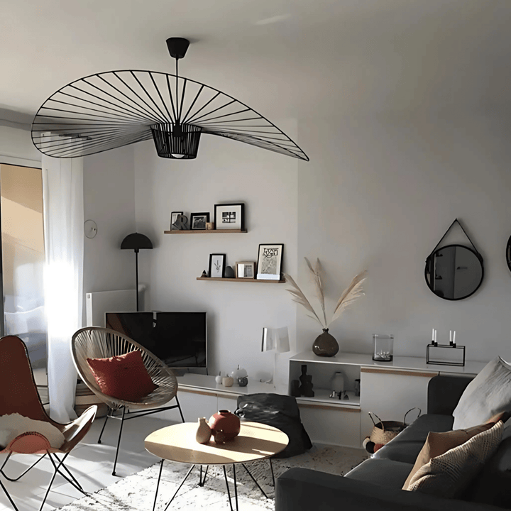 A large, black, fan-shaped pendant light hangs from the ceiling over a living room.