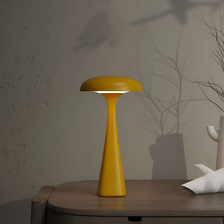 Yellow Jellyfish Desk Lamp with a soft ambient glow on a wooden table.
