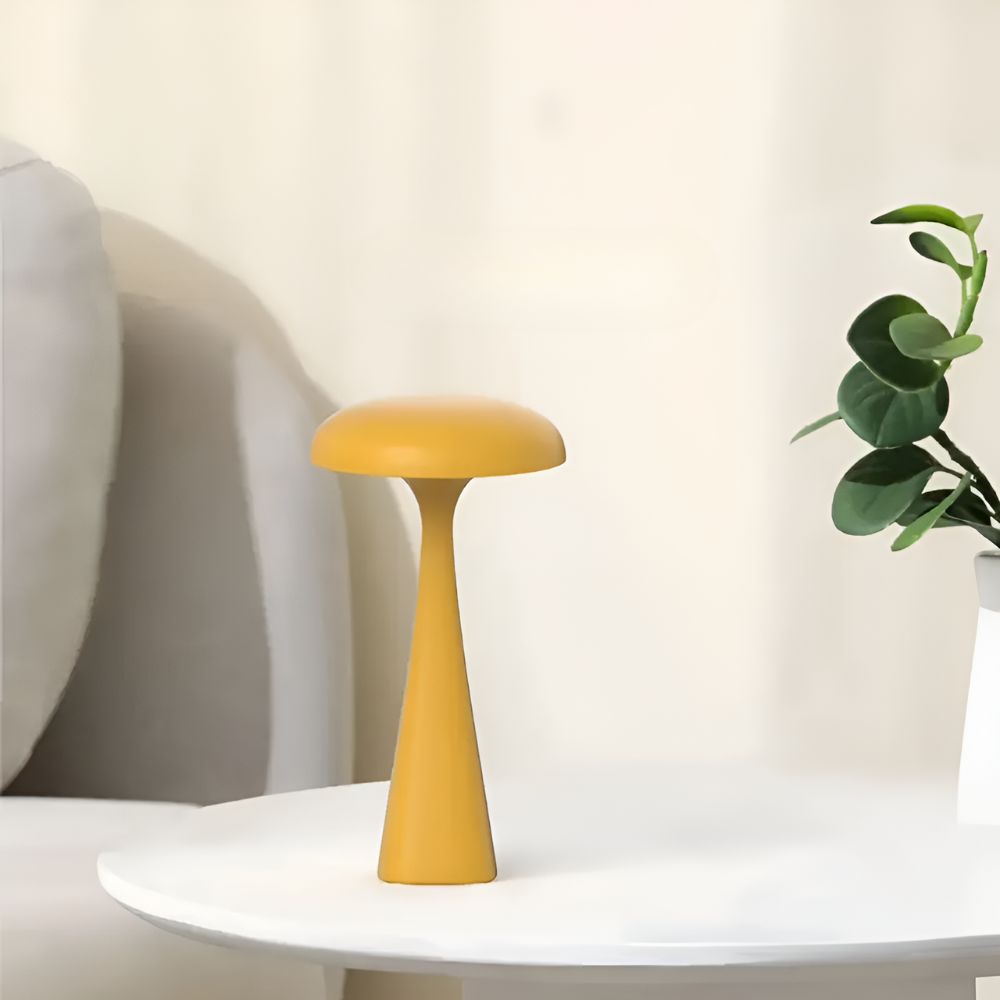 A yellow, jellyfish-inspired cordless desk lamp with a smooth, sculptural silhouette.