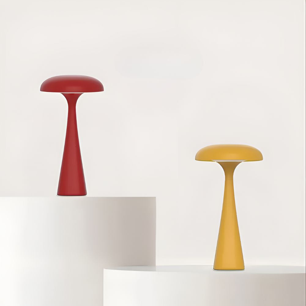 Red and yellow Jellyfish Desk Lamps on white pedestals against a white background.