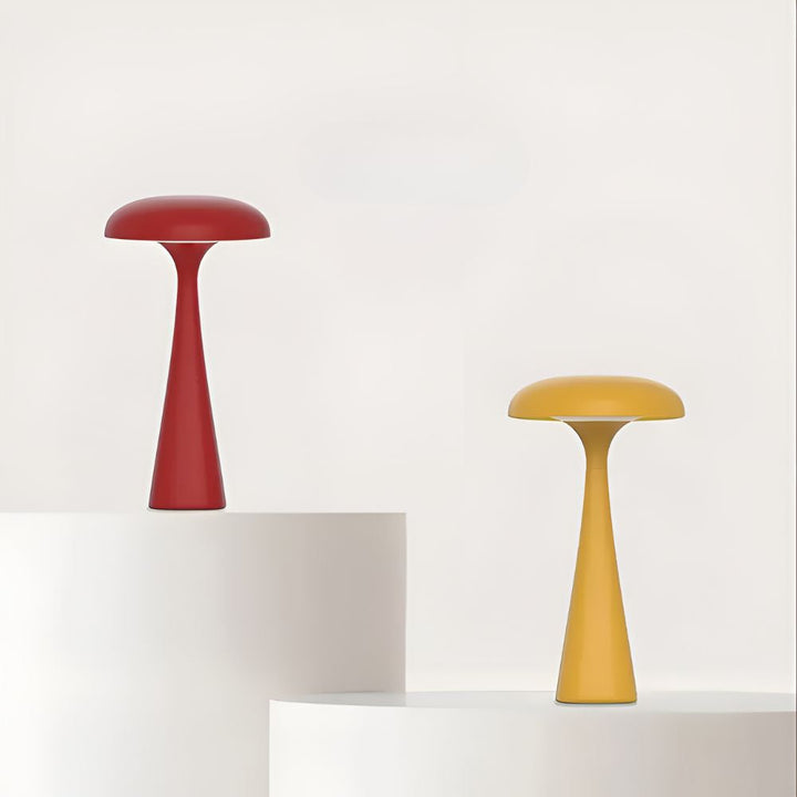Red and yellow Jellyfish Desk Lamps on white pedestals against a white background.