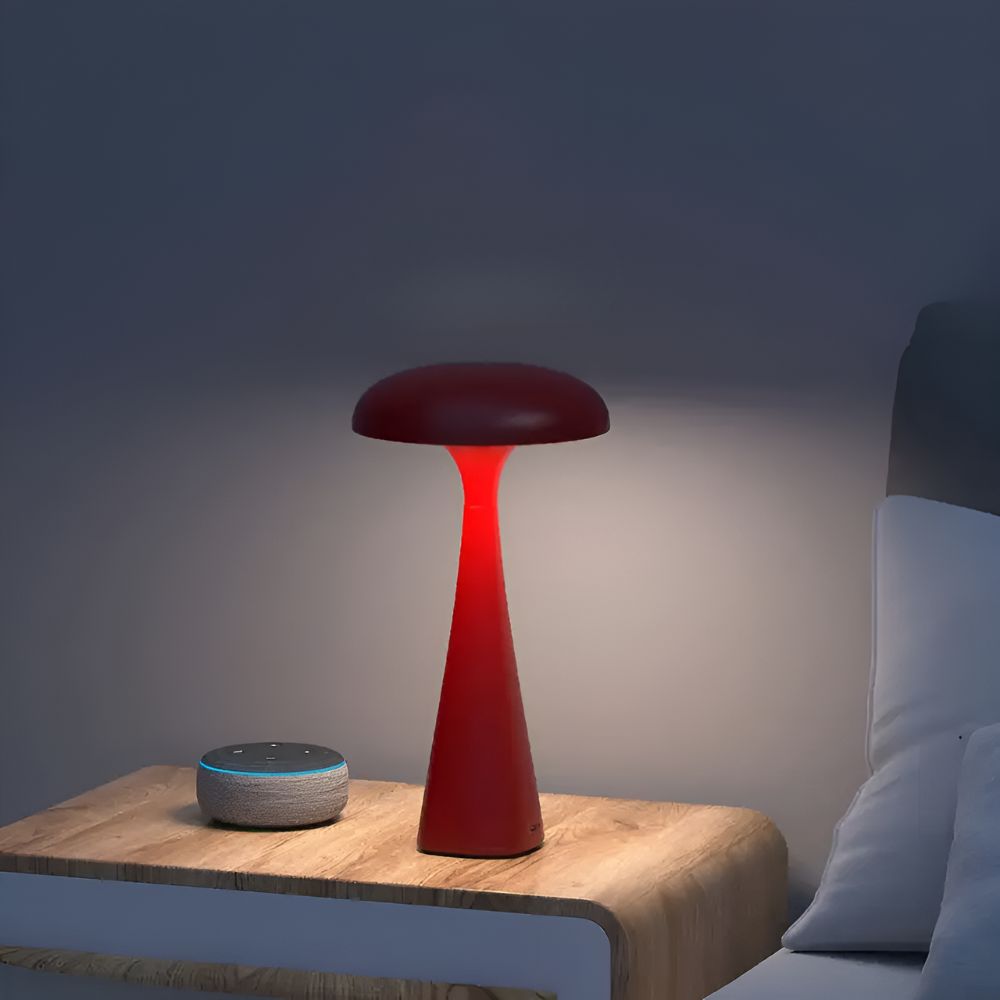 Red jellyfish desk lamp with a soft ambient glow on a nightstand next to a smart speaker.
