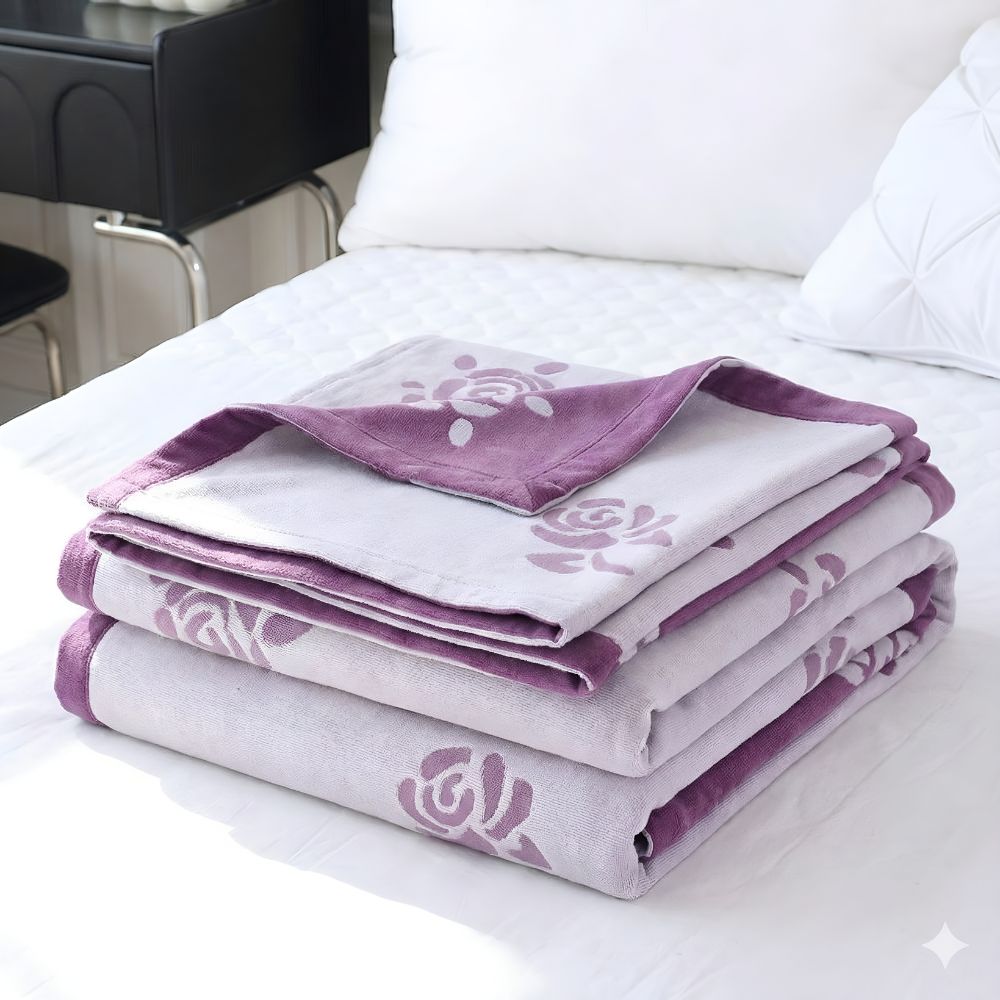Stack of folded bamboo fiber cooling blankets with a purple rose pattern.