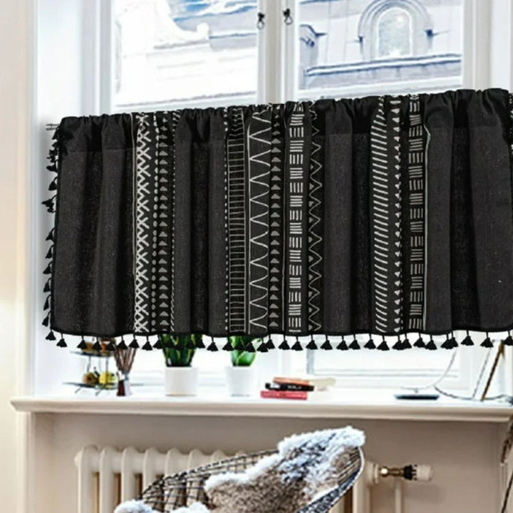 Black linen cabinet curtain with white geometric tribal patterns and tassel trim.