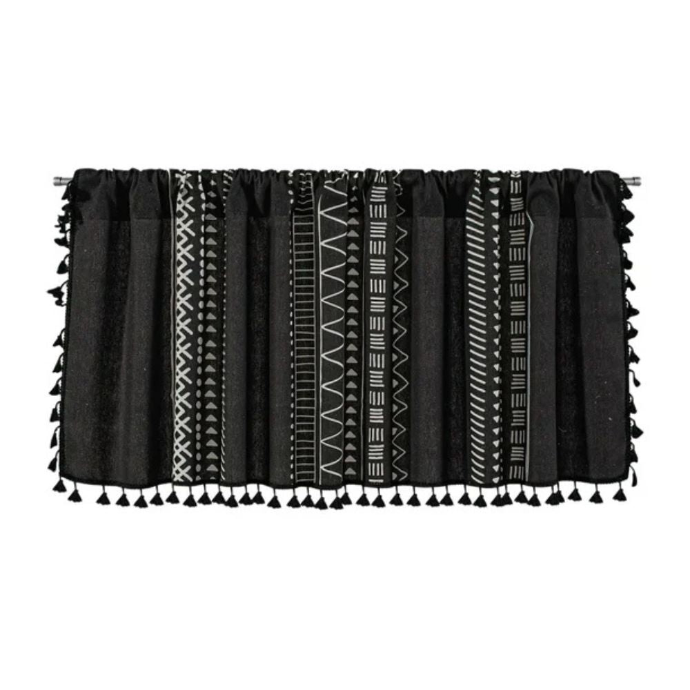 Black cabinet curtain with white geometric tribal patterns and black tassels.