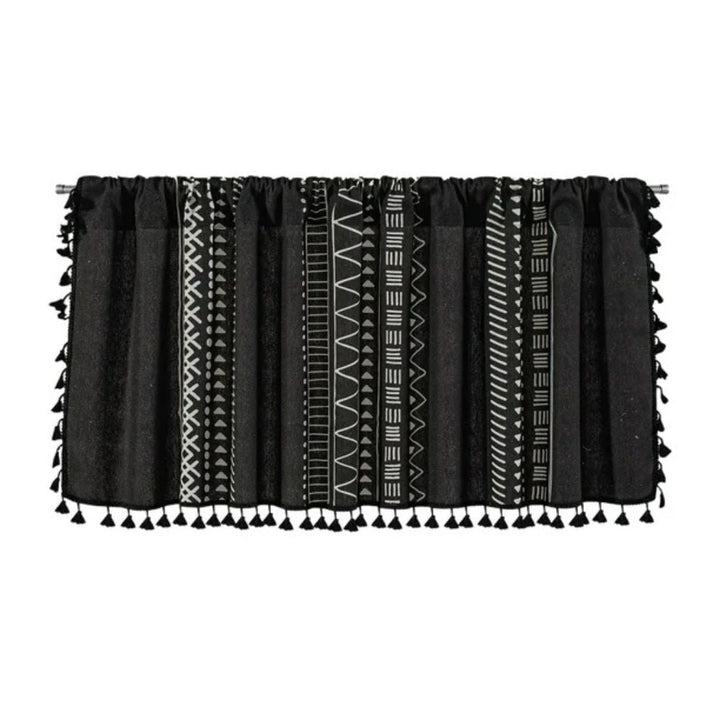 Black cabinet curtain with white geometric tribal patterns and black tassels.