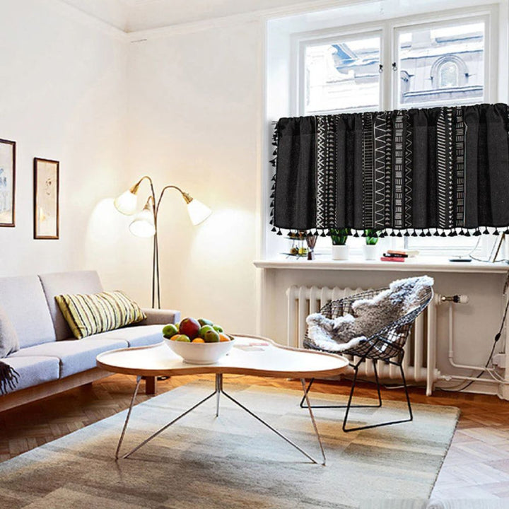 Black geometric tribal tassel cabinet curtain with white patterns and tassel trim.