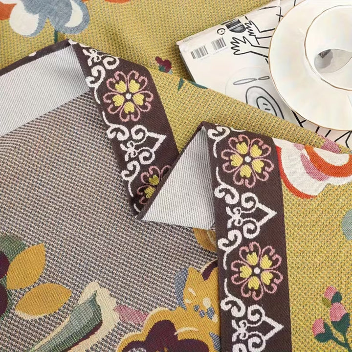 Boho Garden Bird Floral Blanket with brown trim and floral pattern.