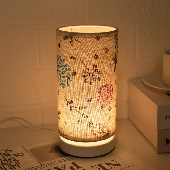 Botanical floral fabric table lamp with a warm ambient glow.