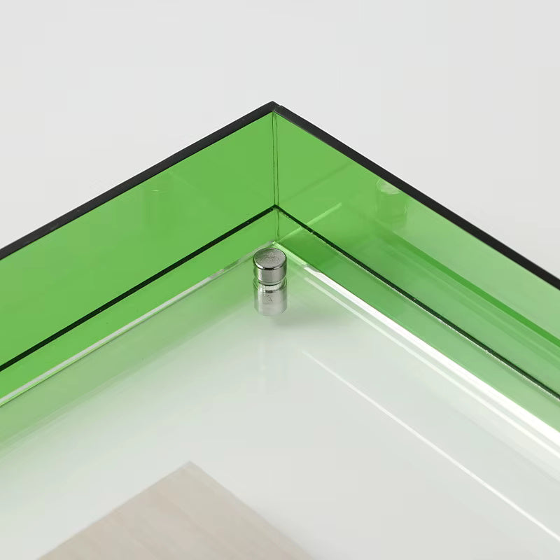 Close-up of a green acrylic picture frame with a silver screw detail.