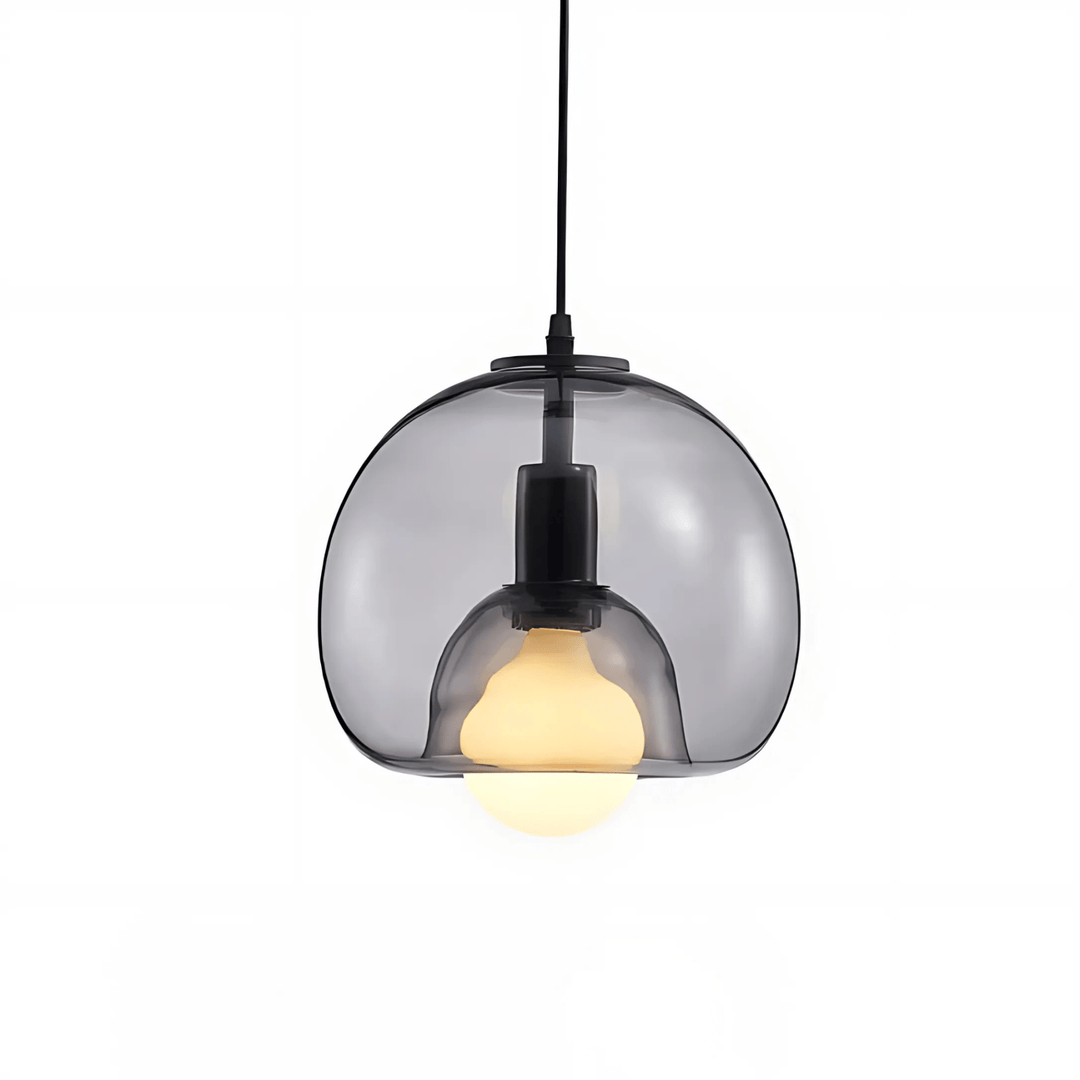 Smoked grey handblown glass pendant light with a warm bulb inside, suspended by a black cord.