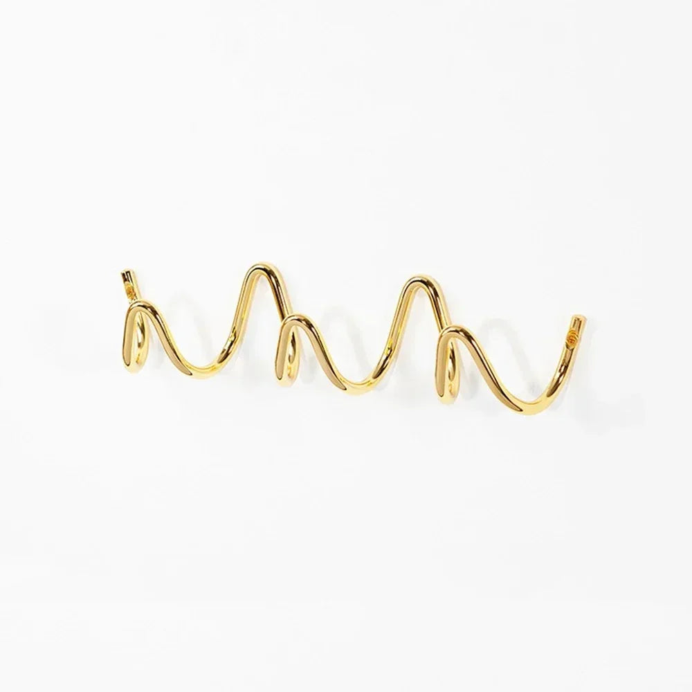 Gold wavy metal wall hook rack with multiple curves.