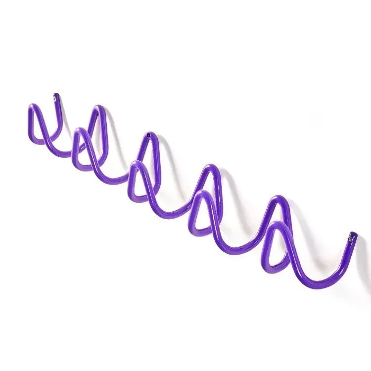 Purple wrought iron wall hook rack with an ocean wave design.