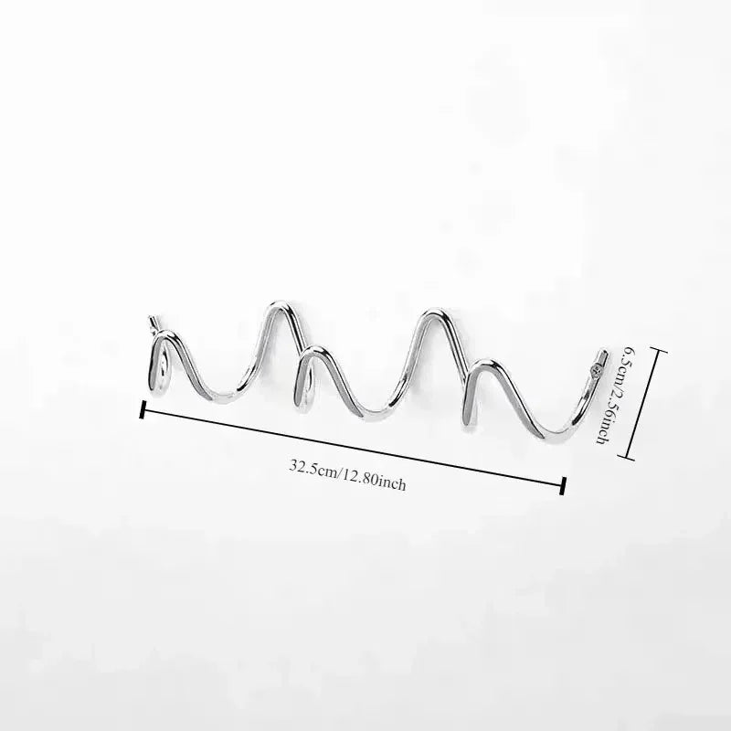 Wrought iron wall hook rack with an ocean wave design, 32.5cm long and 6.5cm deep.