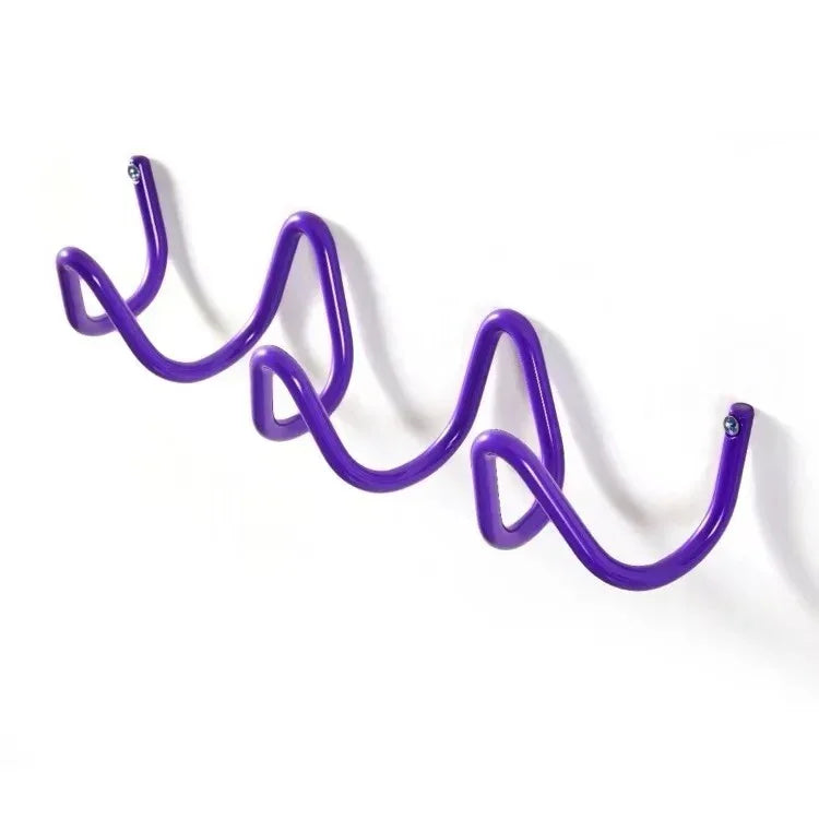 Purple wavy wrought iron wall hook rack with three curves for hanging items.
