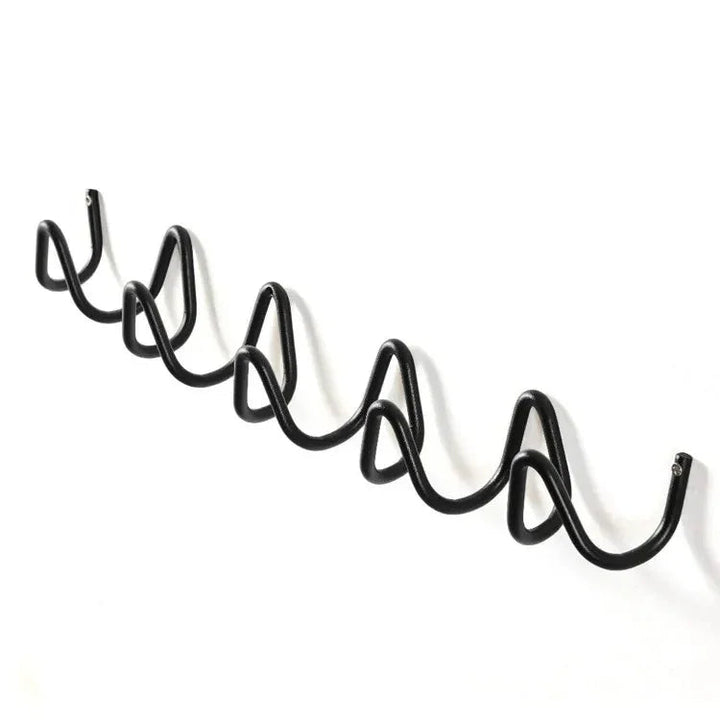 Black wrought iron wall hook rack with an ocean wave design, featuring multiple hooks.