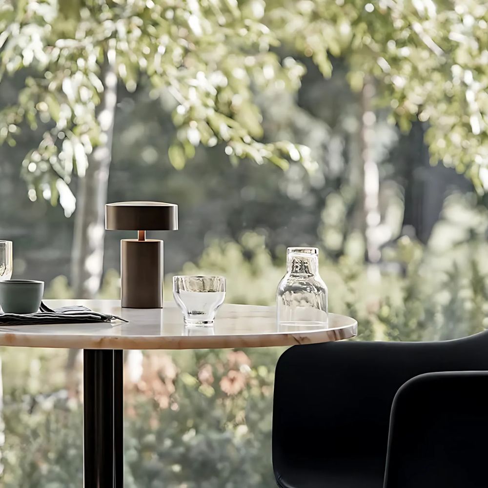 Modern minimalist LED table lamp with a slim column shape on a marble table.
