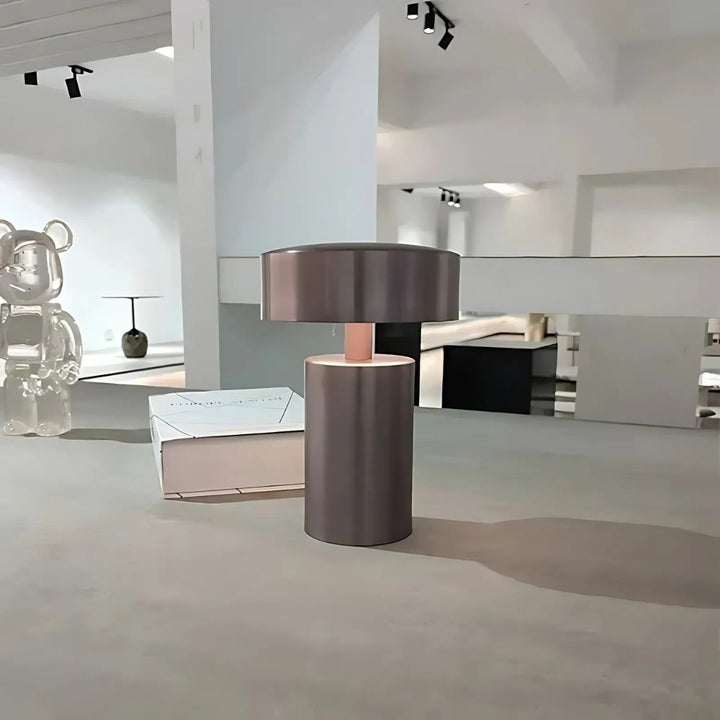 Modern minimalist column LED table lamp with ambient glow on a table.