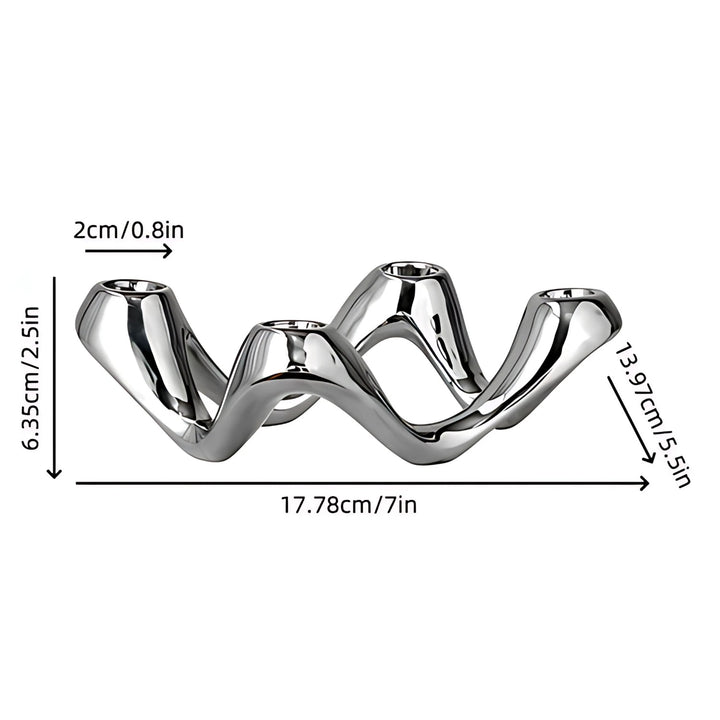 Silver wavy candle holder with dimensions 17.78cm/7in length, 6.35cm/2.5in height, and 2cm/0.8in candle cup diameter.