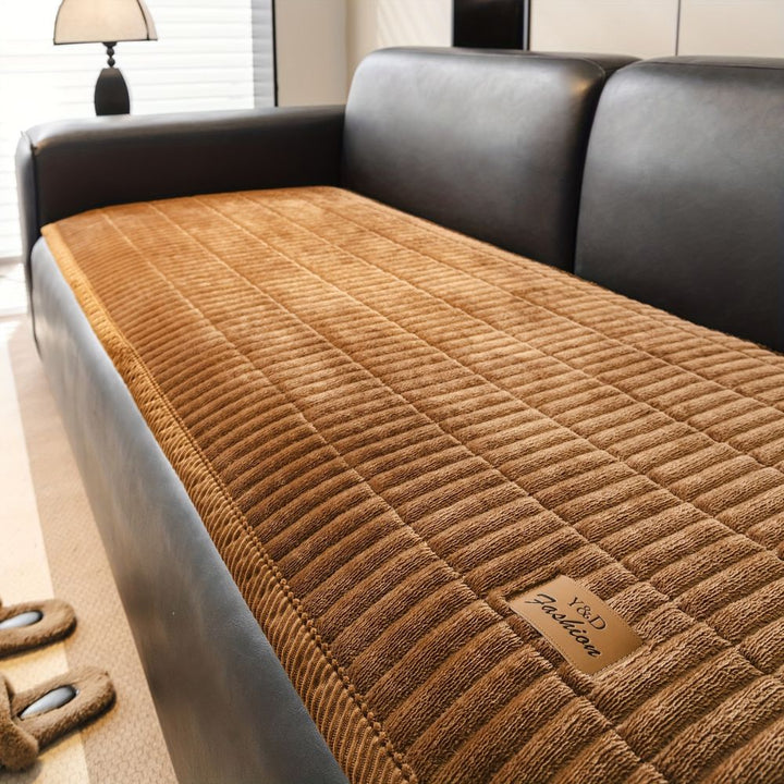 Brown quilted microfiber couch cushion protector with a leather tag that says "Y&amp;D Fashion".
