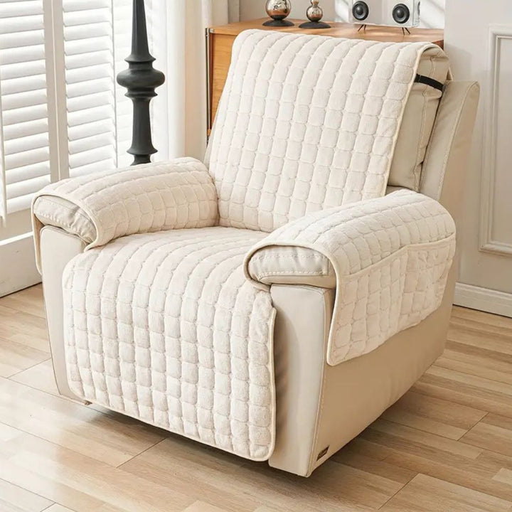 Cream quilted recliner chair cover with side pockets, protecting a beige recliner.