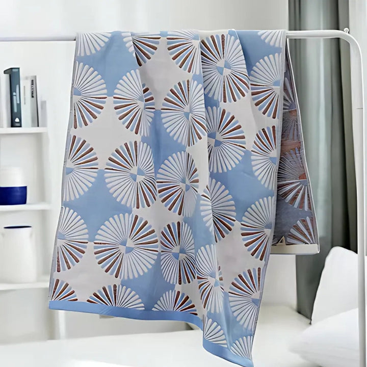 Dahlia Blossom Cotton Bath Towel with a blue and white floral pattern.